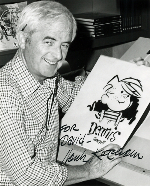 Autographed black-and-white photograph of Hank Ketcham holding a drawing of Dennis the Menace.