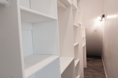 huge closet, built-in white cupboards, Dark hardwood floors