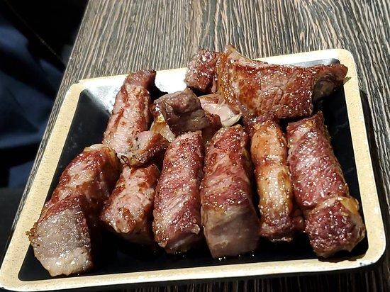 Small cuts of cooked steak.