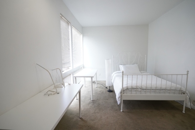 White bedroom, white table, white computer desk and white bed