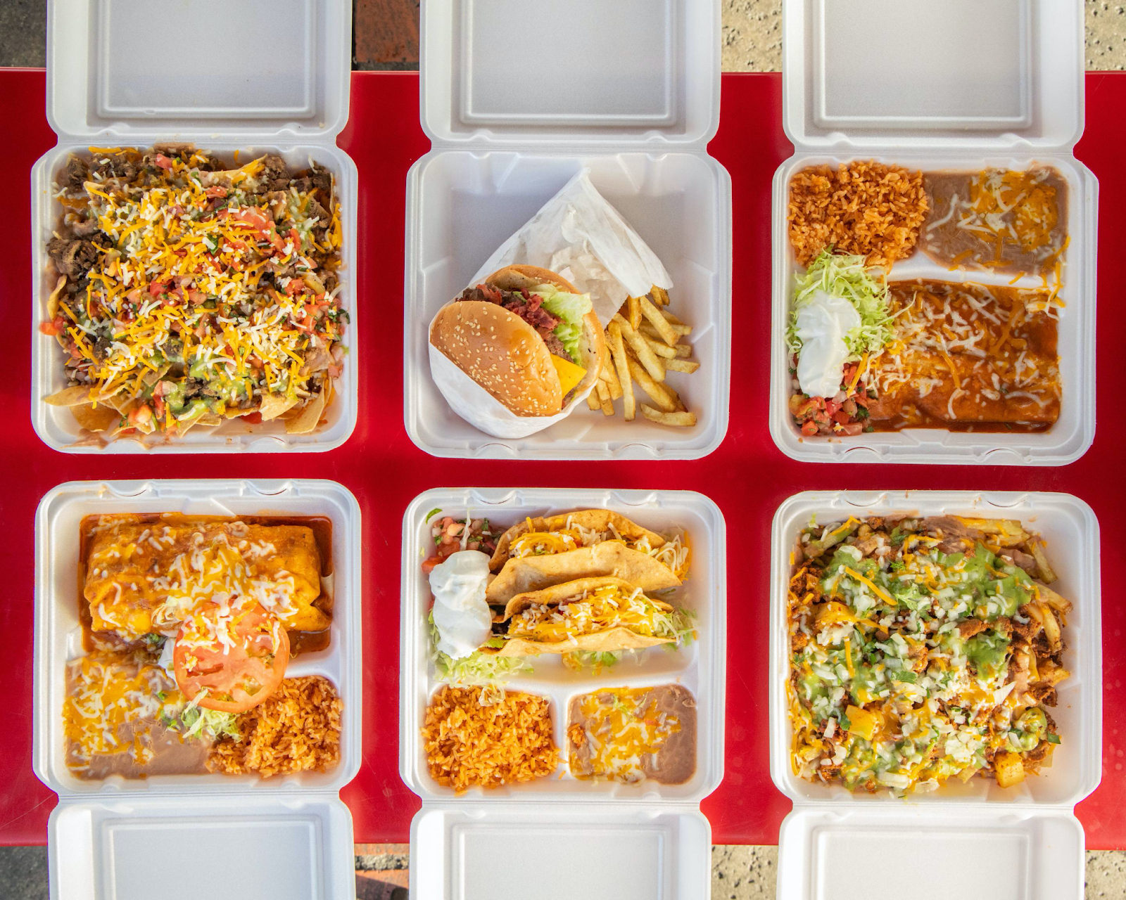 A variety of takeaway containers filled with Mexican food from El Huero’s.