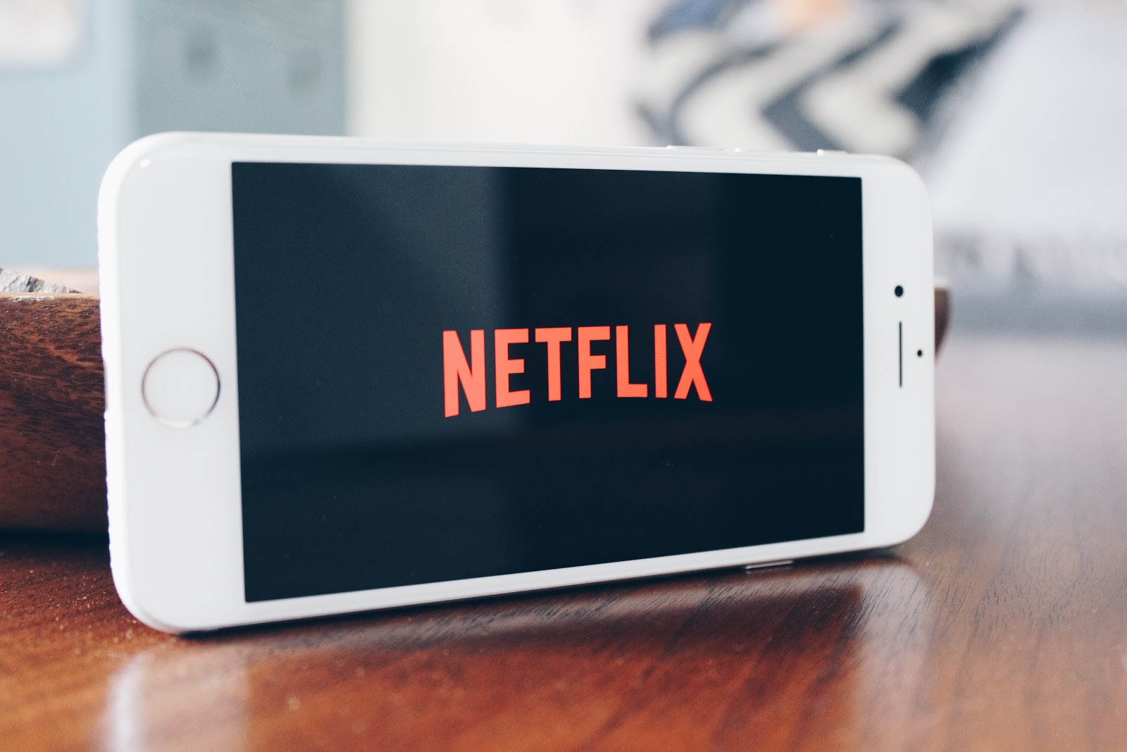 iPhone turned sideways with Netflix logo on screen 