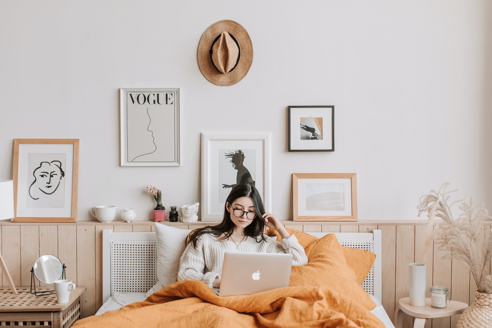 College student using her MacBook in her living room 