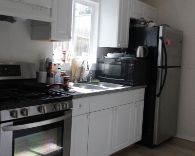 kitchen with black microwave and black fridge 