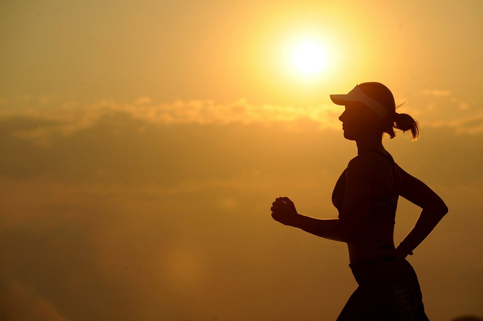 silhouette of woman jogging 
