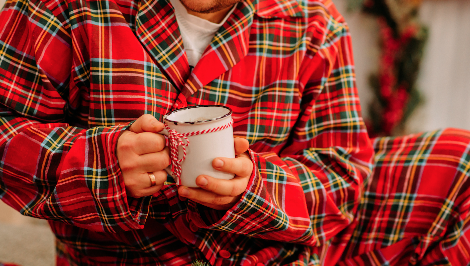 a person in pajama set dressing holding tea