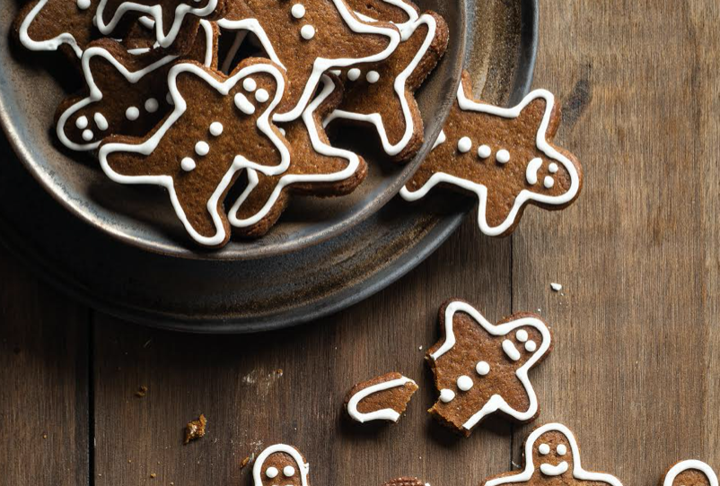 A pate of gingerbread men on a wood table