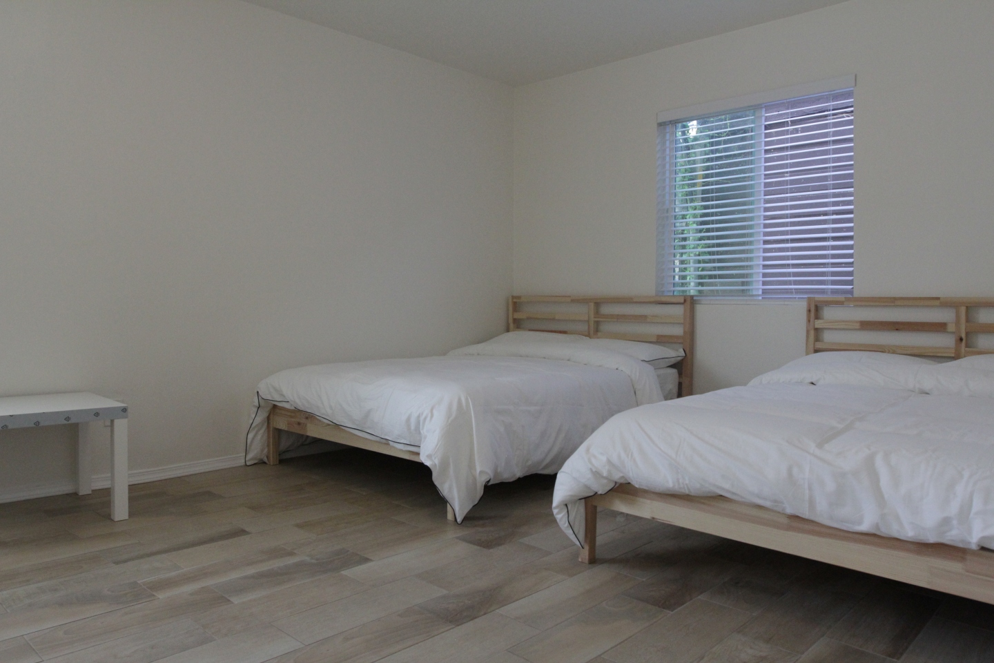 two white beds in co-living space 