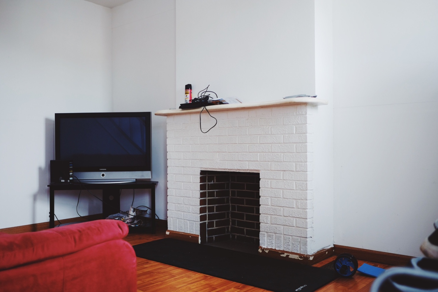 white fireplace, brown wood panels