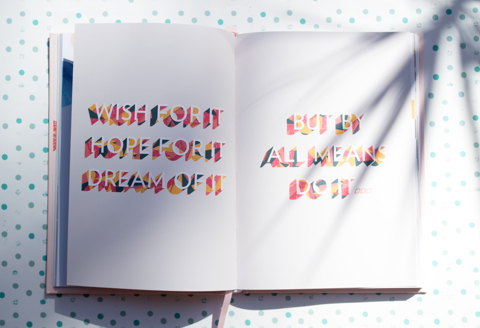open motivational book with multicolored huge inspiration quote 