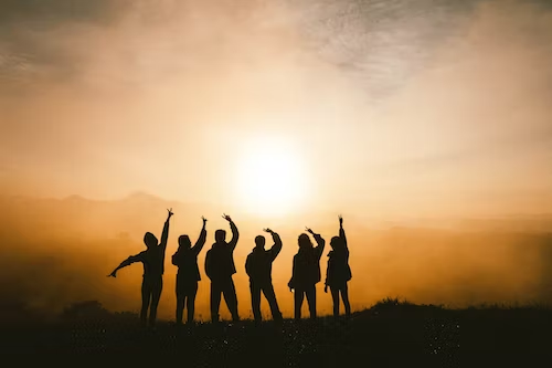 Silhouette photo of six people on top of mountain.