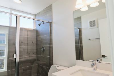 clean bathroom, bright, glass sliding shower 