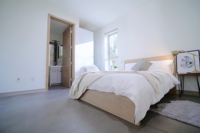 bright bedroom with white fluffy bed 